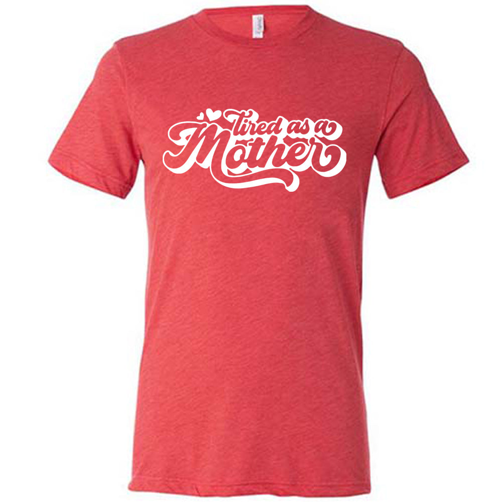 red unisex tee with the words "tired as a mother' on it, with a couple little hearts at the start