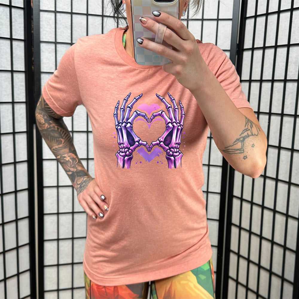 coral shirt with a skeleton heart hand graphic on it
