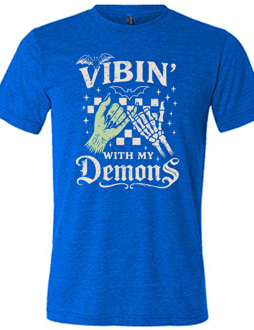 blue unisex tee with words saying "Vibin' with my Demons", around the graphic of the hands of a zombie and a skeleton doing a pinky promise, in front of a checkered background, and one line-drawn bat and one detailed bat on top, and scattered stars