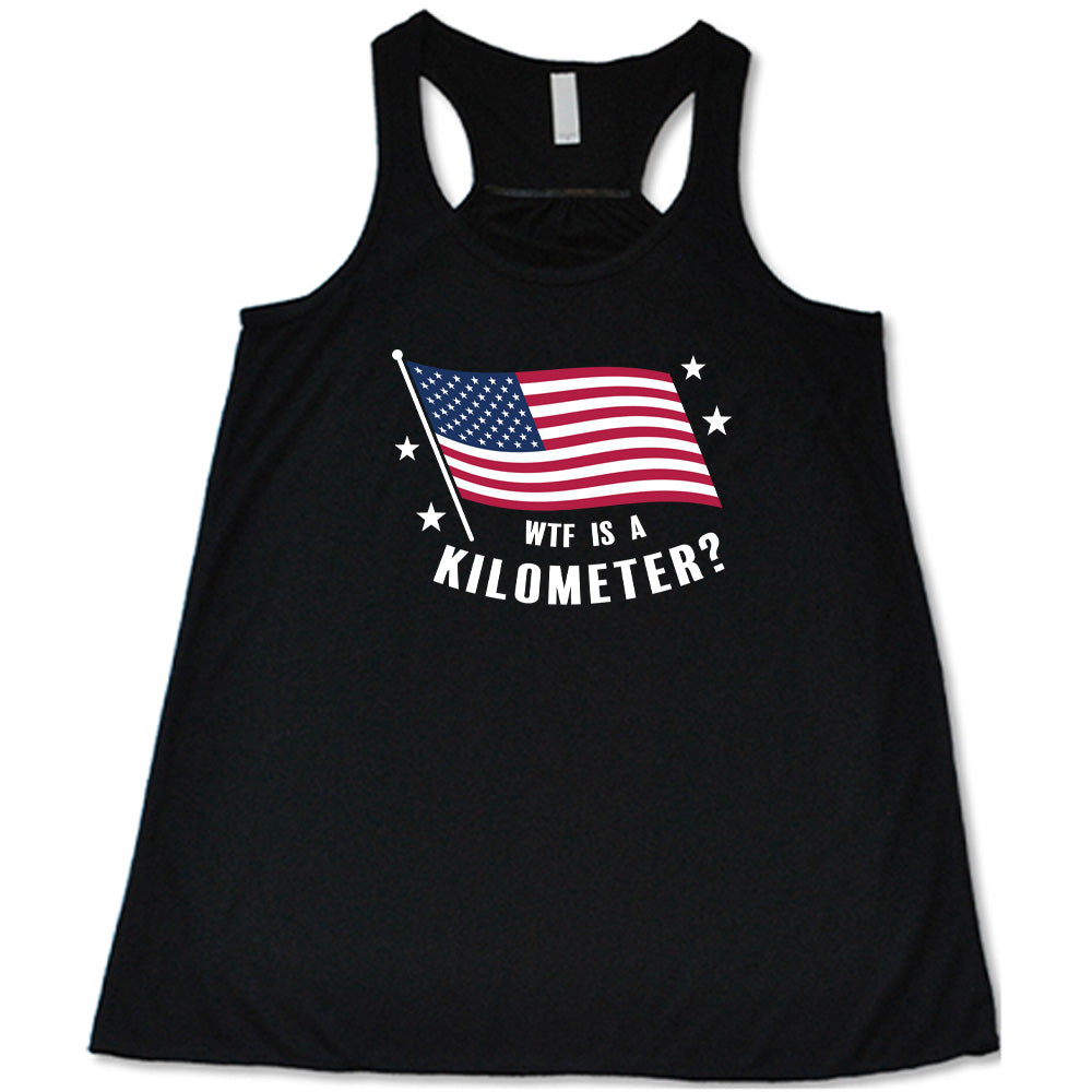 Black colored flowy tank with an American flag graphic on it that says "WTF Is A Kilometer?"