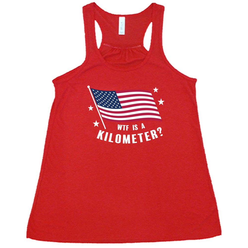 Red colored flowy tank with an American flag graphic on it that says "WTF Is A Kilometer?"