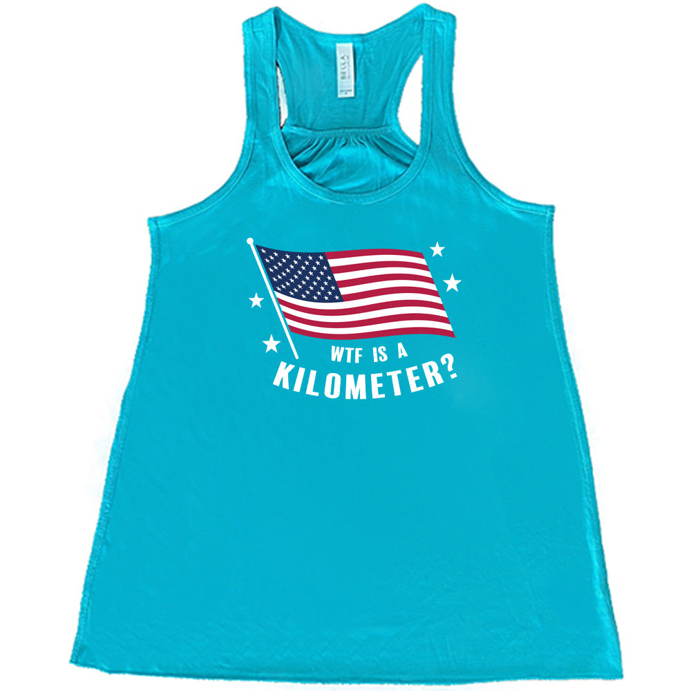 Teal colored flowy tank with an American flag graphic on it that says "WTF Is A Kilometer?"