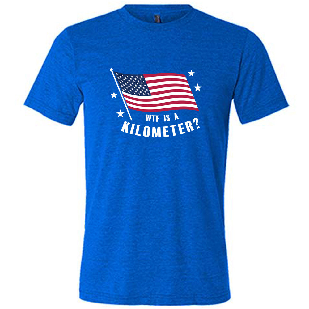Blue colored shirt with an American flag graphic on it that says "WTF Is A Kilometer?"