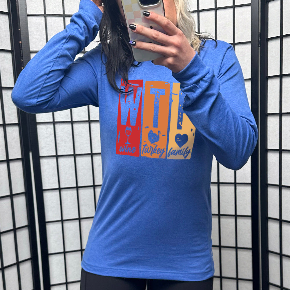 heather true royal long sleeve shirt with a graphic on it that says "WTF" and under the "W" there's a graphic of a wine glass and the word "wine"; under "T" there's a graphic of a turkey and the word "turkey"; under F there's a graphic of a heart and the word "family"
