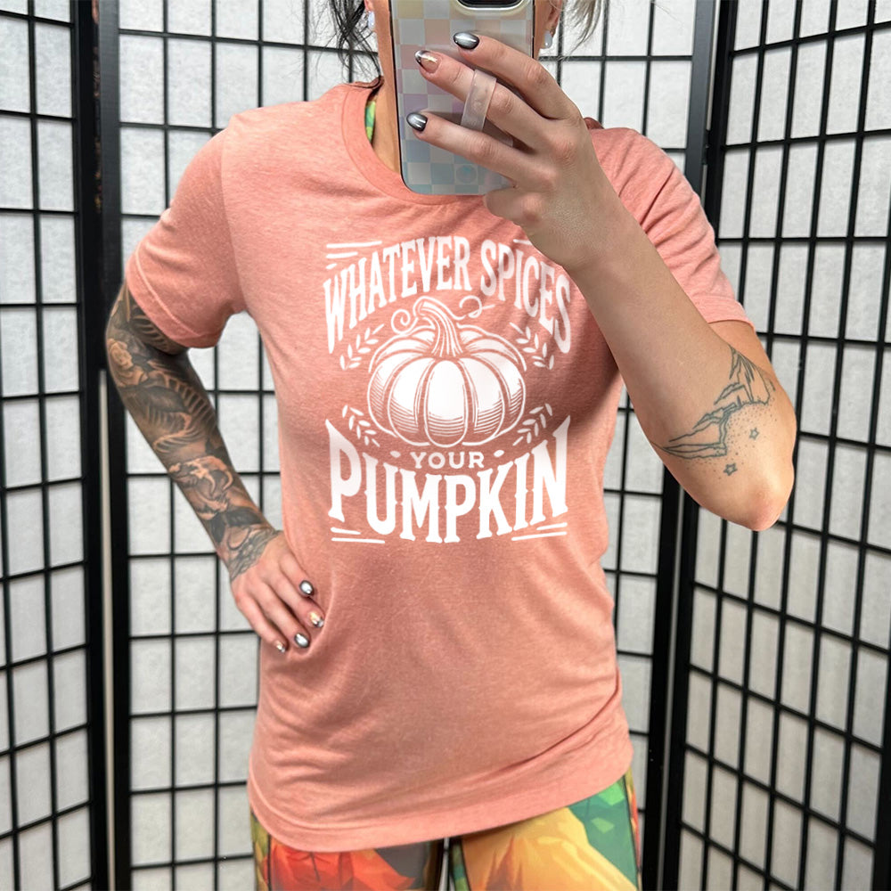 Model wearing sunset colored shirt with pumpkin graphic on it that says "Whatever Spices Your Pumpkin"