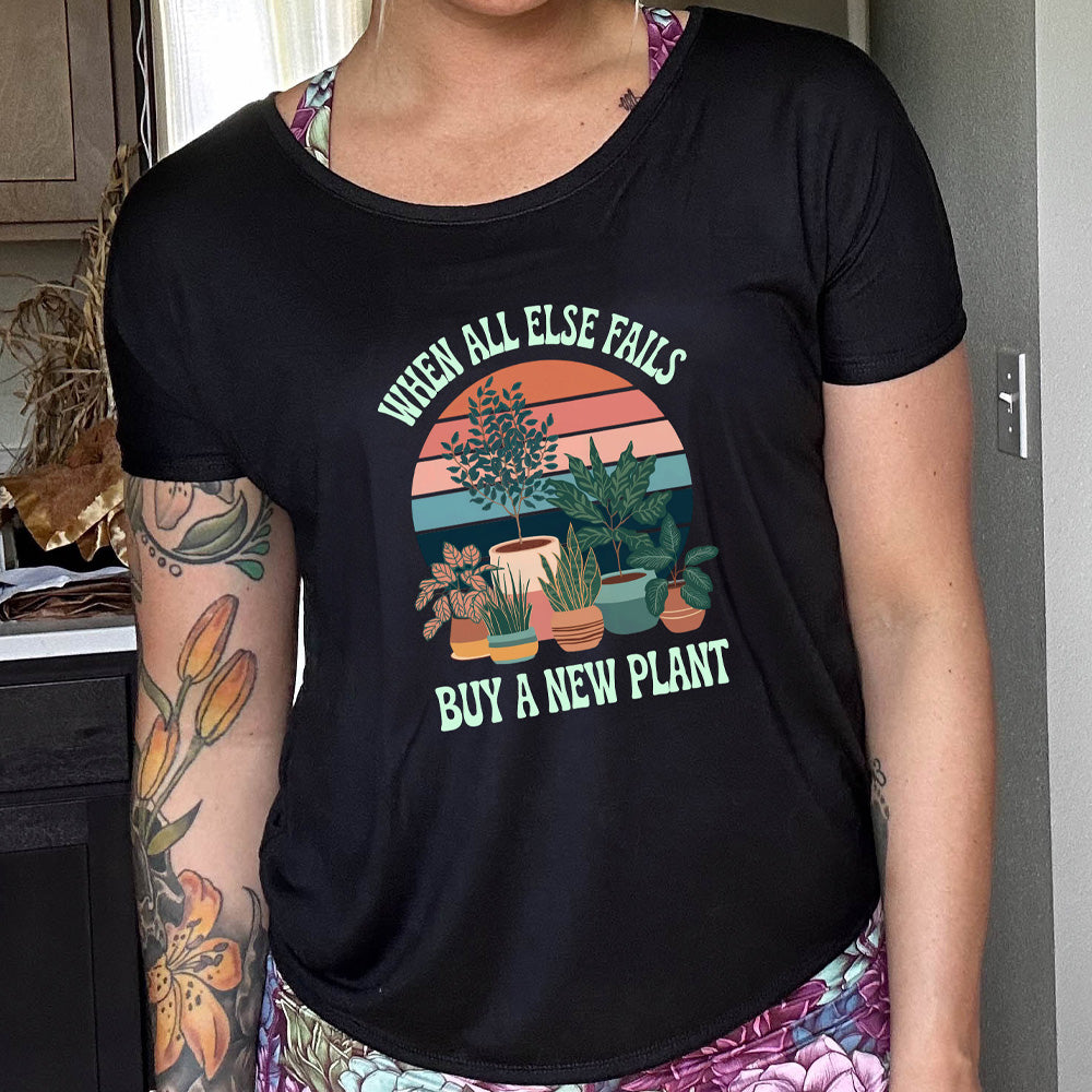 Person wearing a black t-shirt with a plant-themed graphic and text.
