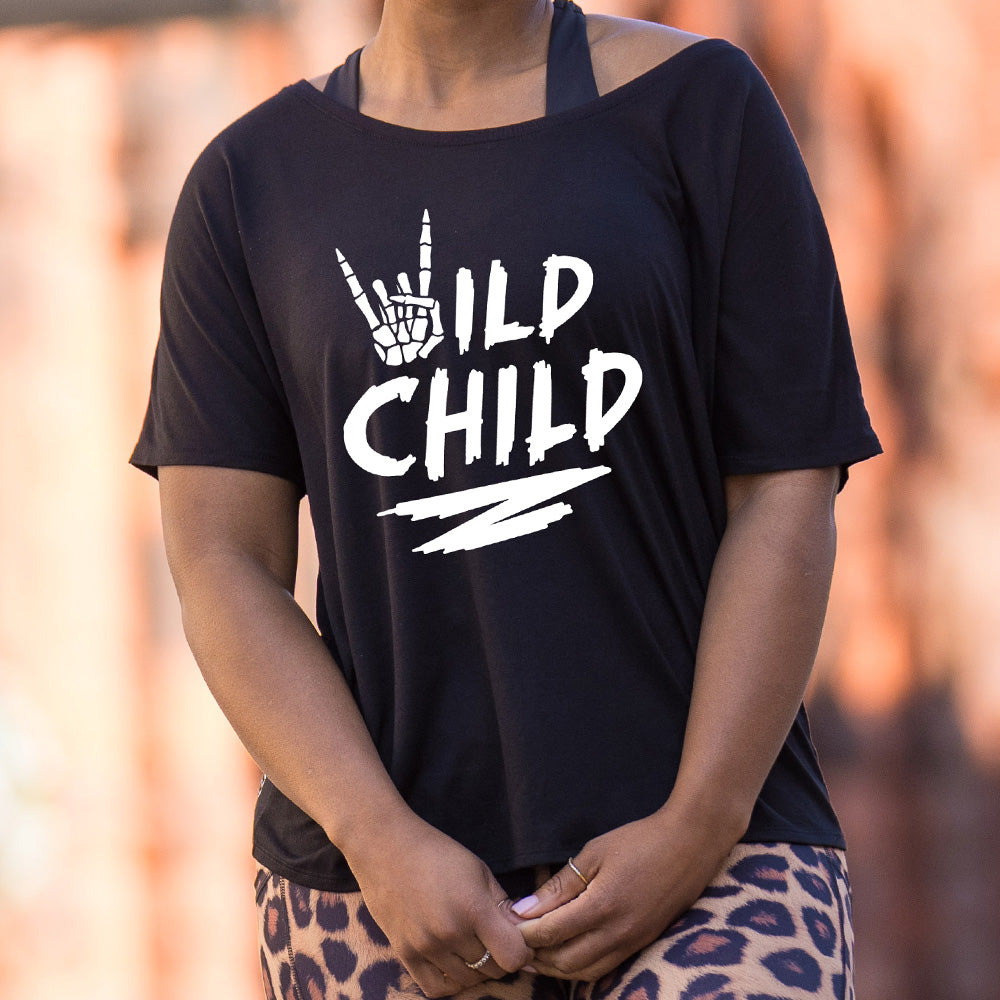 shirt with a skeleton hand signing rock on graphic on it that says "Wild Child"