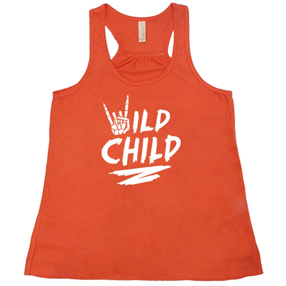Coral colored flowy tank with a skeleton hand signing rock on graphic on it that says "Wild Child"