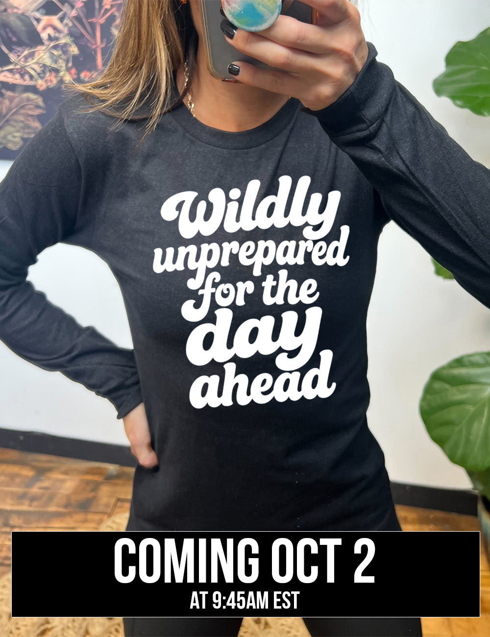 heather black long sleeve tee with words on it saying "Wildly unprepared for the day ahead" coming October 2nd