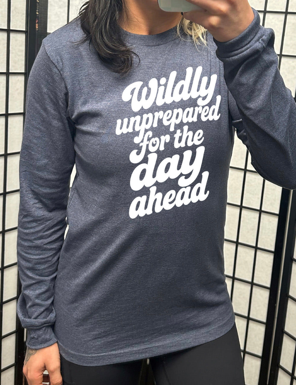 heather navy long sleeve tee with words on it saying "Wildly unprepared for the day ahead"