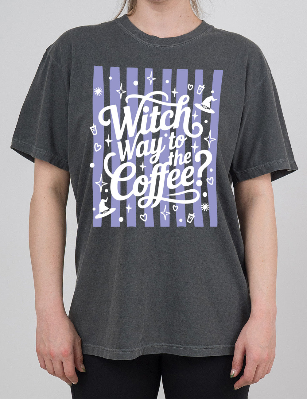 pepper modern tee with the words "witch way to the coffee?" on it, over a striped background, surrounded by little graphics including stars, hearts, witch hats, coffee cups, dots, and suns