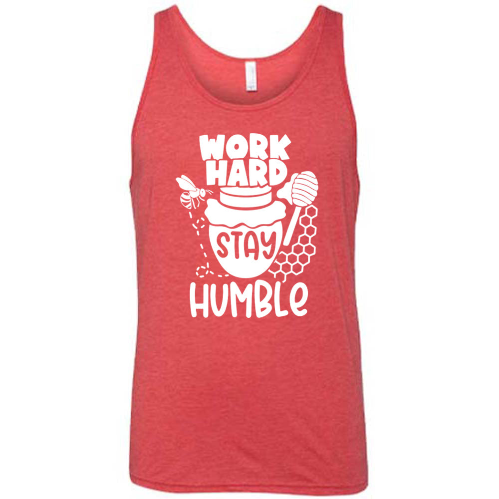 red unisex tank with the words "work hard stay humble" on it, with the word "stay" on the graphic of a honeypot, and a bee flying around the pot's left, and some honeycomb and a honey spoon on its right