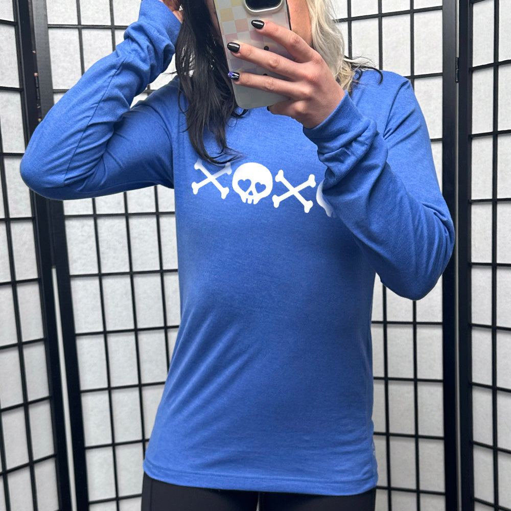 heather true royal long sleeve shirt with graphics of crossed-bones and skulls (with hearts for eyes) forming the phrase "XOXO"