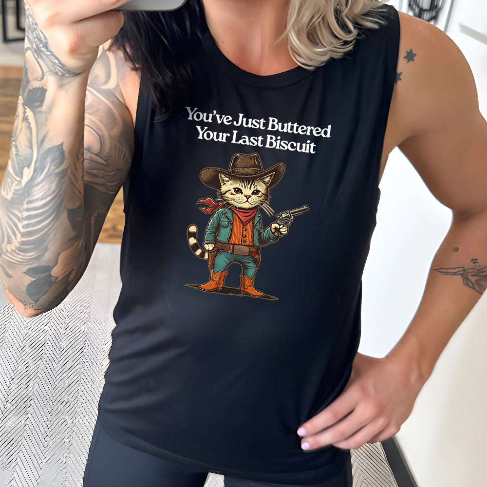 black muscle tank with a cat wearing a cowboy hat graphic on it that says "You've Just Buttered Your Last Biscuit"