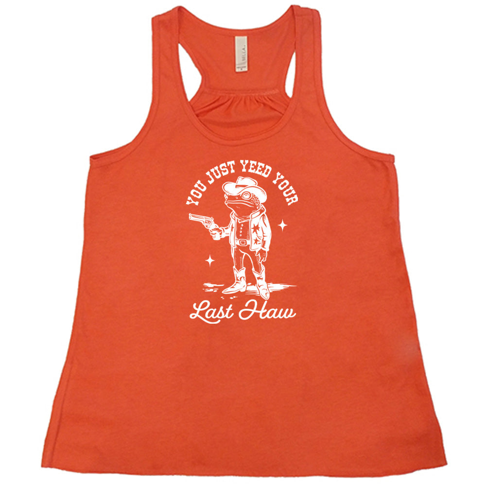 Coral colored flowy tank with a cowboy frog graphic on it that says "You Just Yee'd Your Last Haw"