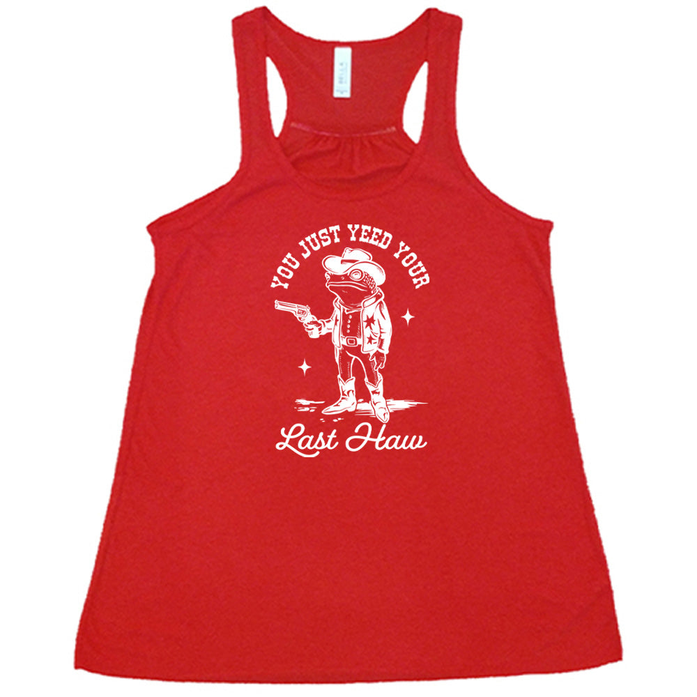 Red colored flowy tank with a cowboy frog graphic on it that says "You Just Yee'd Your Last Haw"
