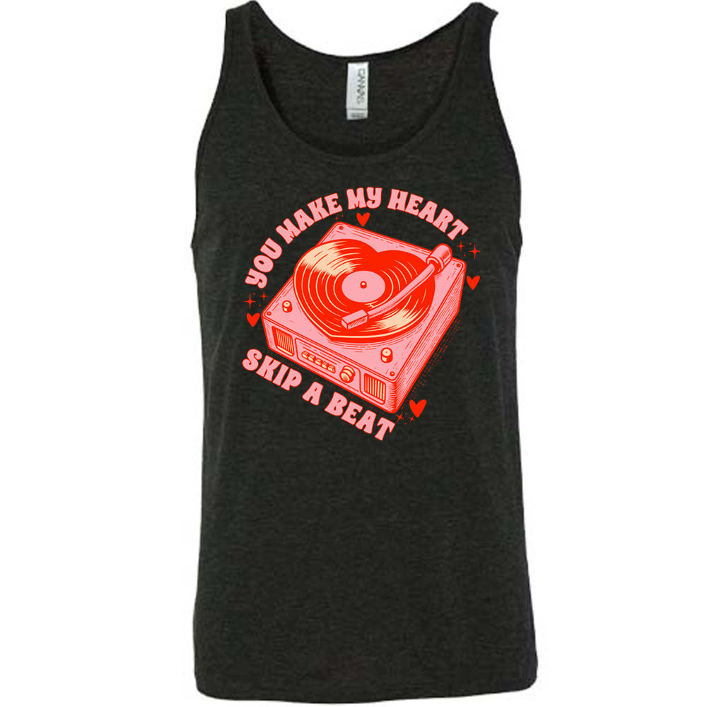 black unisex tank with the words "you make my heart skip a beat" on it, with the graphics of a record player, with a record shaped like a heart, with a little hearts and stars around each corner of the player