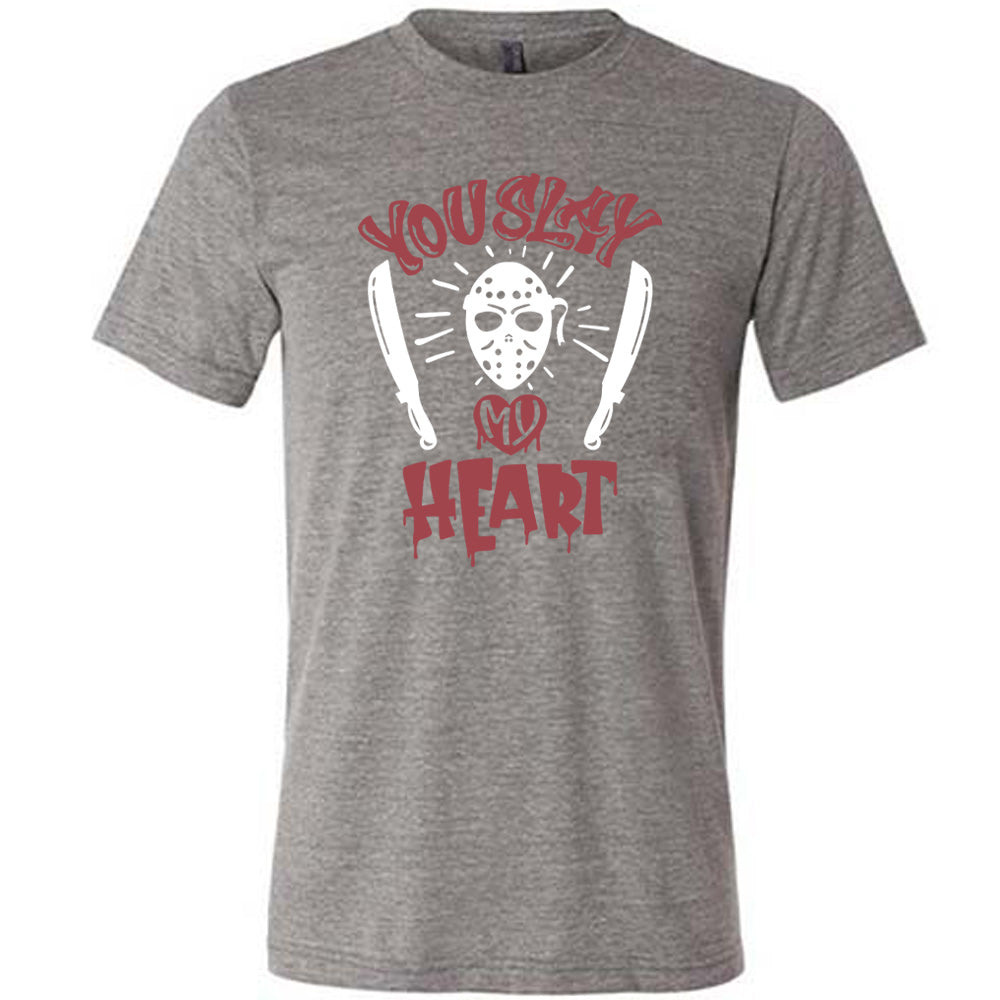 grey unisex tee with the words "you slay my heart" on it in horror movie style writing, with "my' being in a dripping heart, and graphics of the Jason mask from Friday the 13th and two machetes