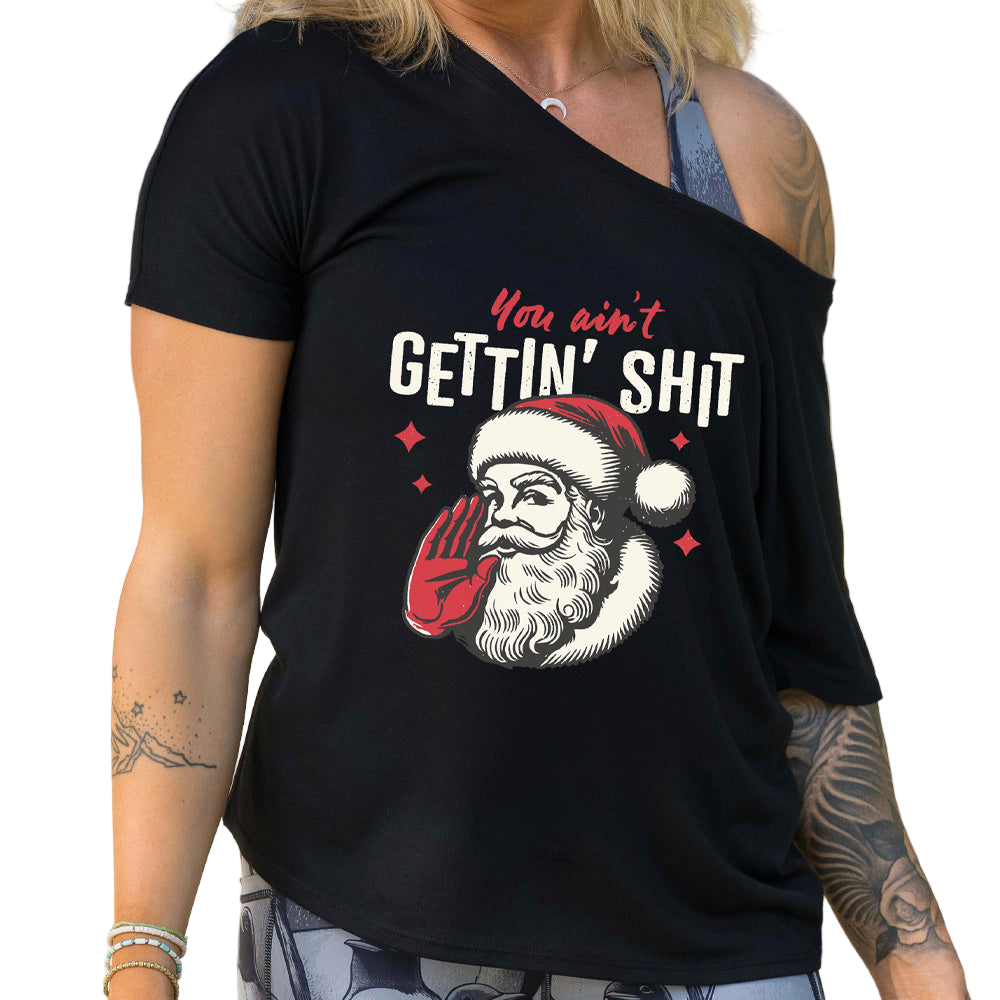 Person wearing a black t-shirt with a graphic design featuring Santa Claus and text.