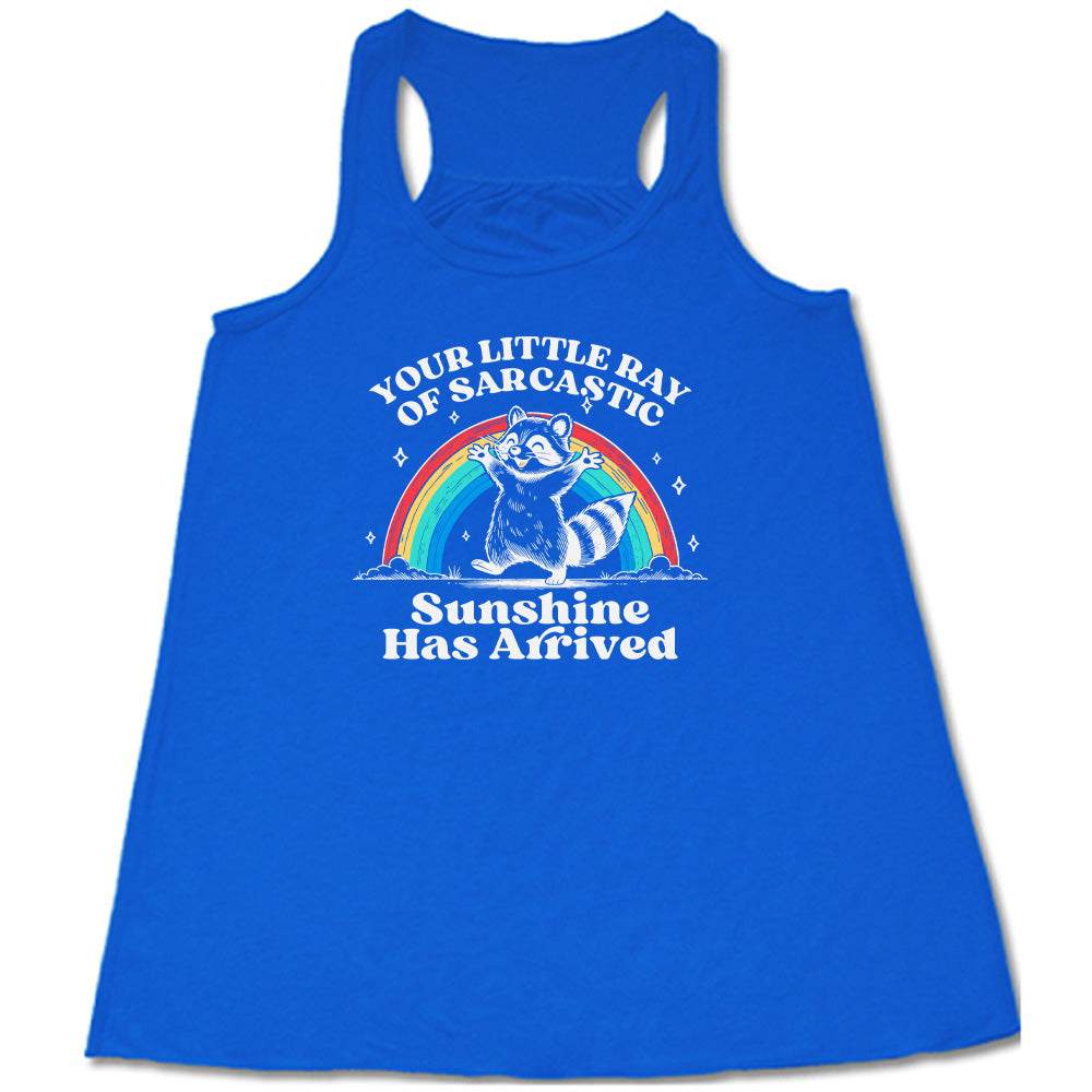 Blue colored flowy tank with a rainbow and raccoon graphic on it that says "Your Little Ray of Sarcastic Sunshine Has Arrived"