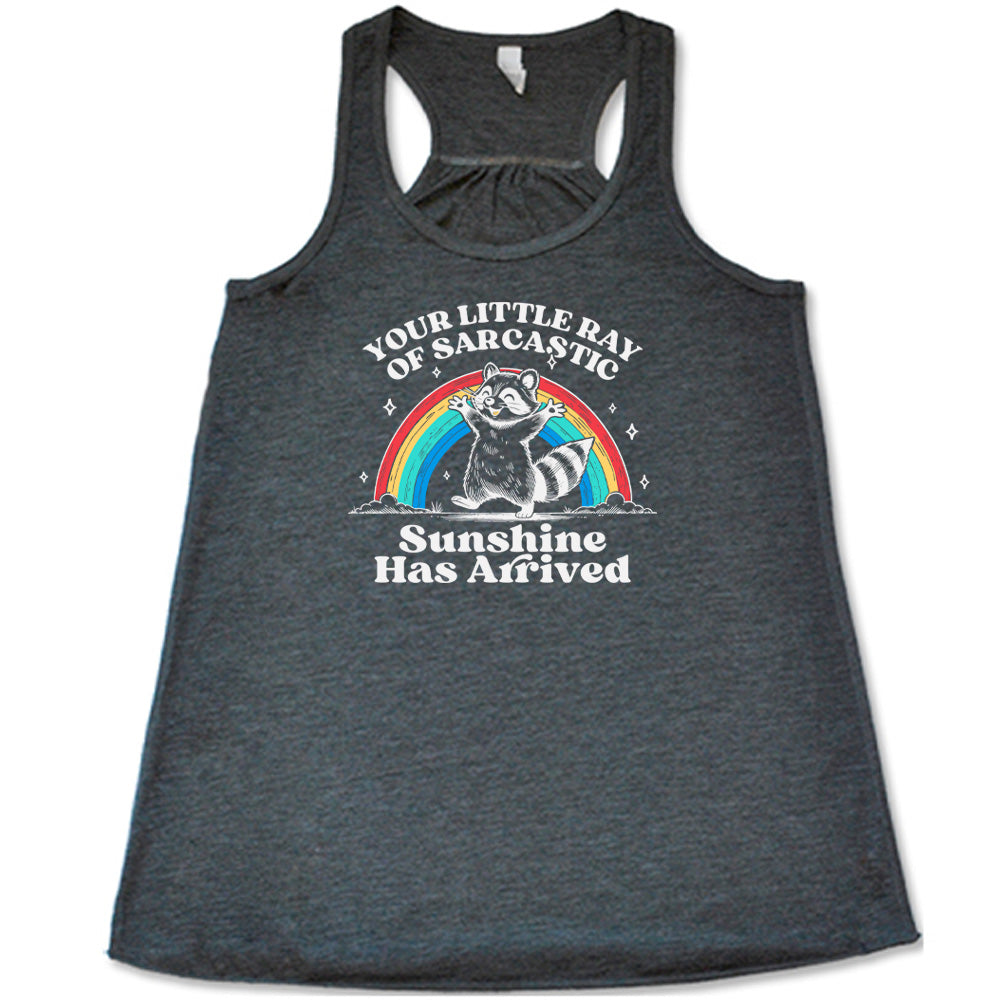 Grey colored flowy tank with a rainbow and raccoon graphic on it that says "Your Little Ray of Sarcastic Sunshine Has Arrived"
