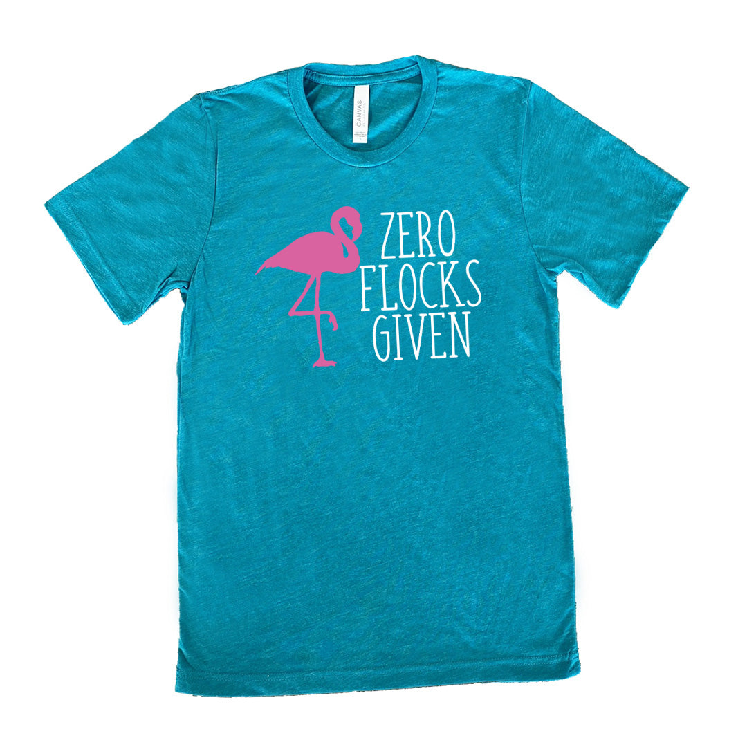 teal unisex tee with the words "zero flocks given" on it, with the pink silhouette of a flamingo, leg raised, next to the words