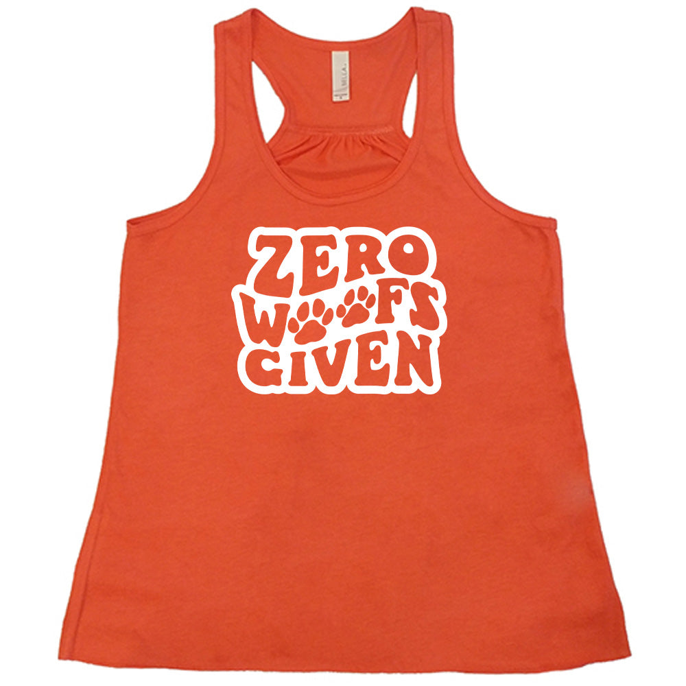 Coral colored flowy tank with paw print graphic on it that says "Zero Woofs Given"