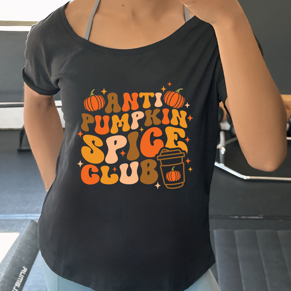 Person wearing a black t-shirt with 'ANTI PUMPKIN SPICE CLUB' text and graphics.