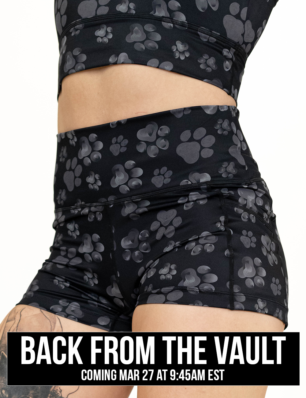 close up of the 2.5 inch grey paw prints against a black background shorts, coming soon