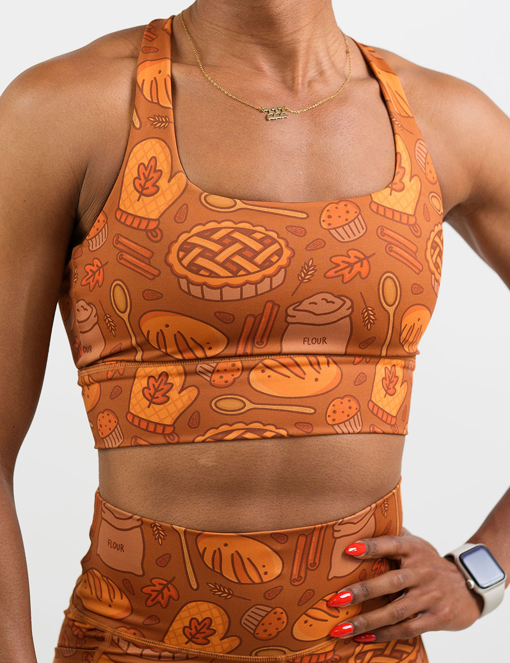 front of the orange baking themed sports bra against a white background