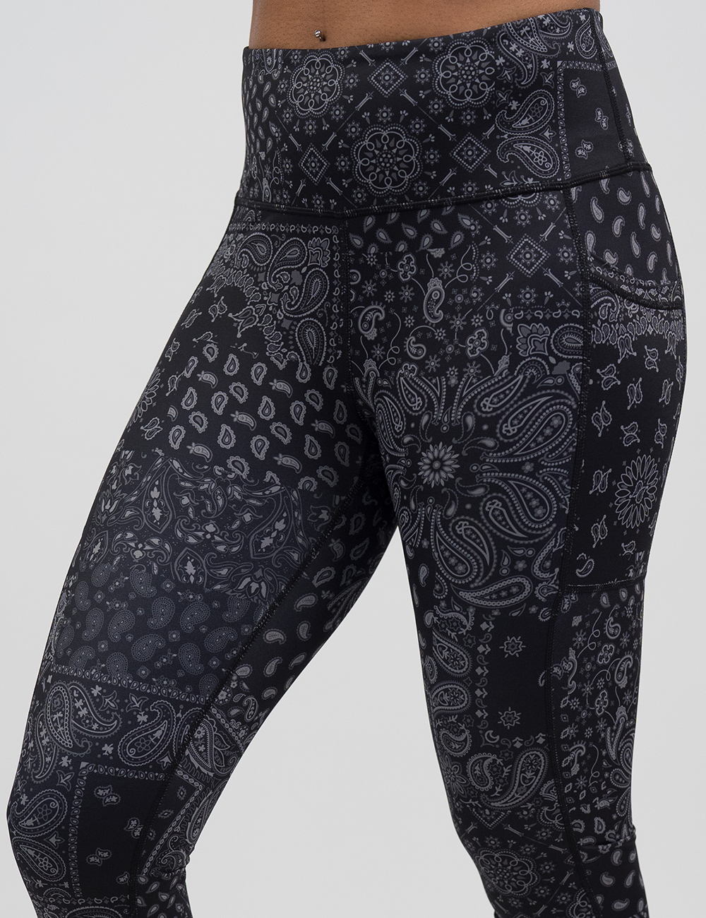 black paisley patterned leggings against a white background