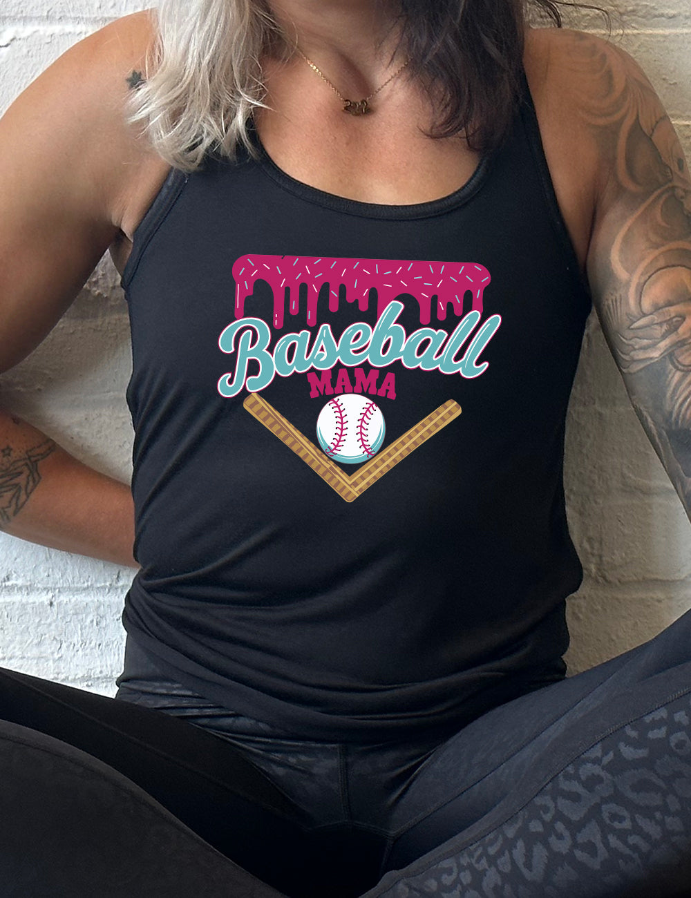 black flowy racerback tank with the words "baseball mama" on it, with a border with sprinkles above the words, dripping down, and a baseball underneath the words, and a border in a V below everything