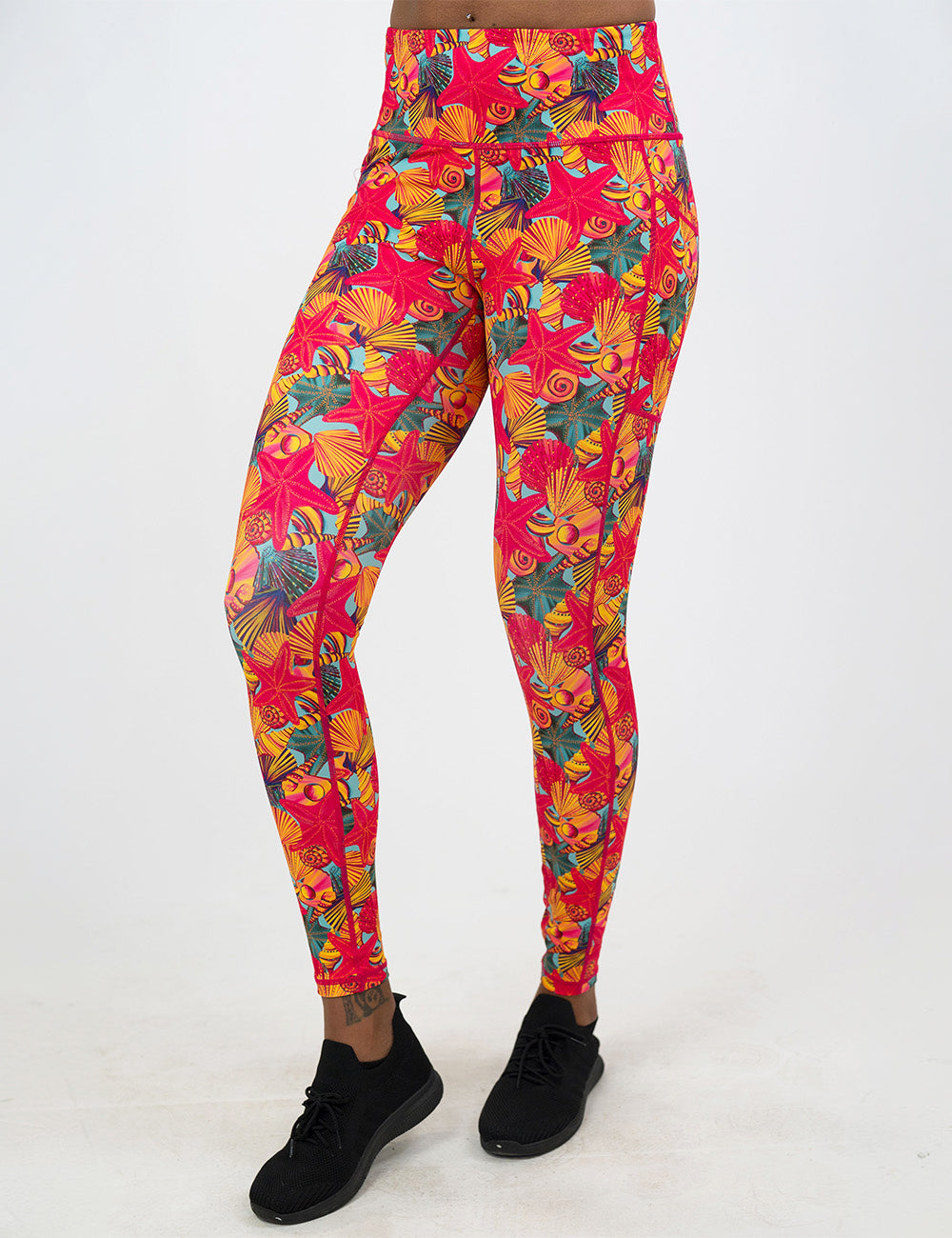 front of the front of the red starfish with a yellow and blue shell background full length leggings against a white background