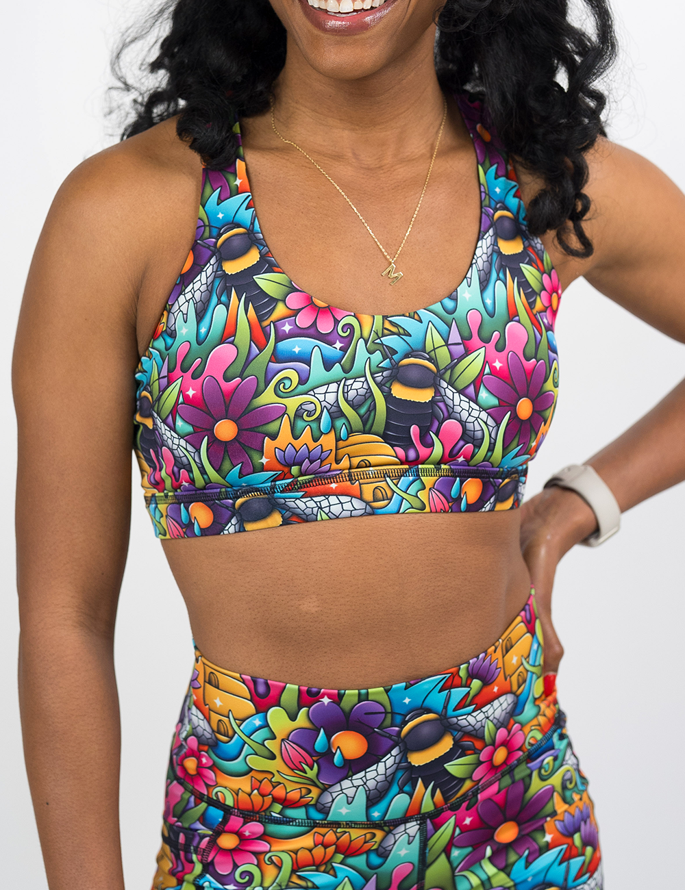 front of the cartoon bees among colorful cartoon flowers print butterfly back bra against a white background