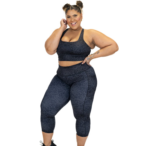 model wearing black lotus leggings and matching sports bra
