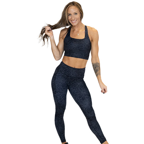 model wearing black lotus leggings and matching sports bra