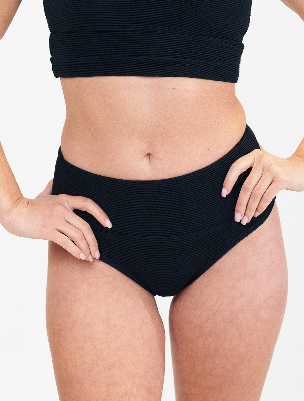 model wearing black bathing suit bottoms