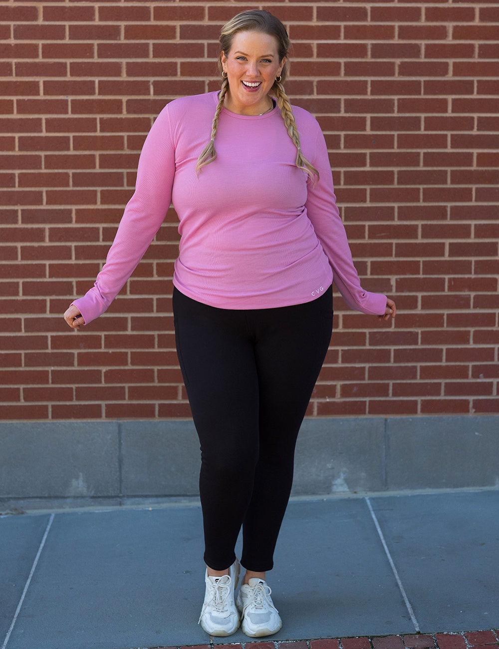 model wearing the solid black fleece lined leggings and a pink thermal shirt