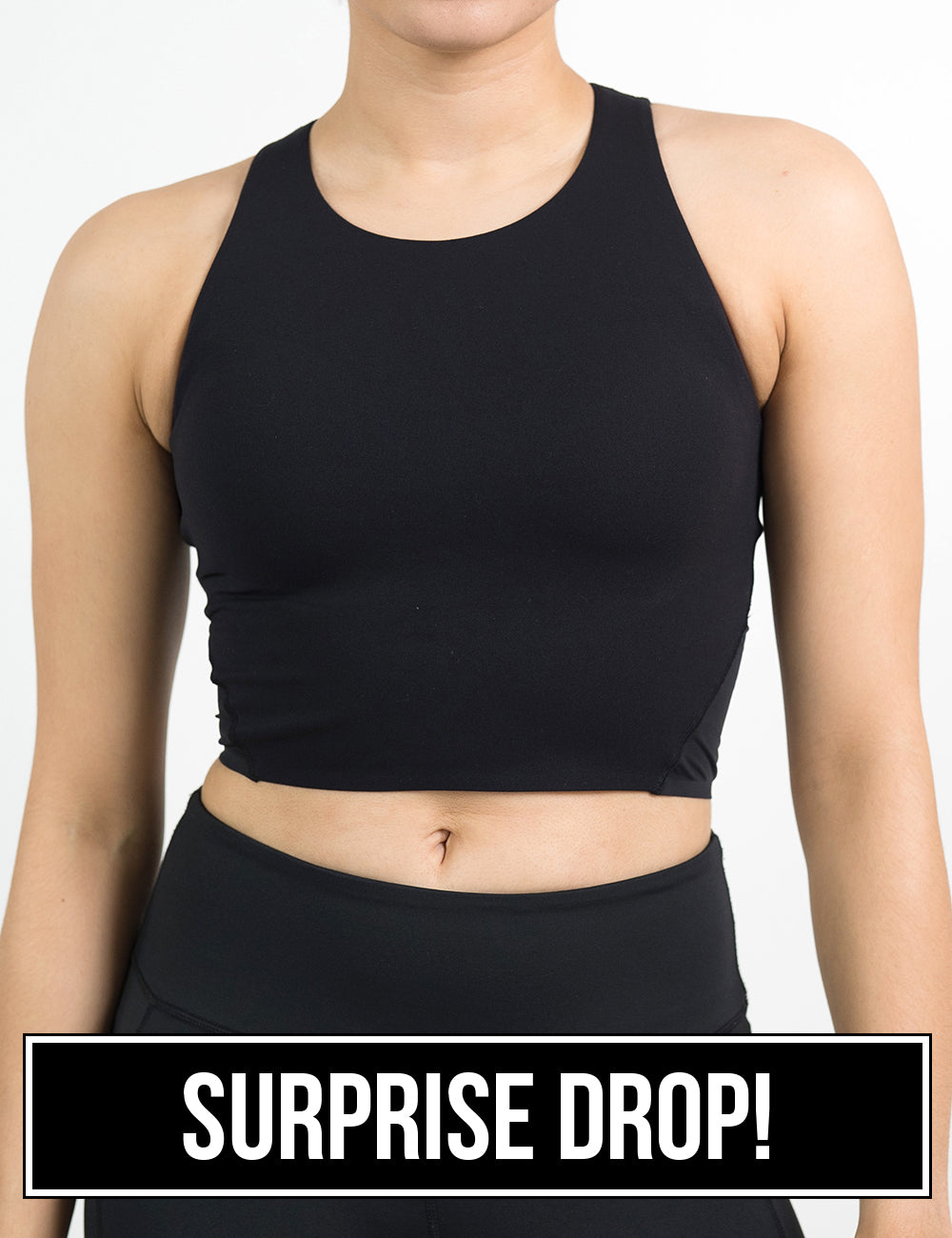 front of the black cropped tank top against a white background, surprise drop