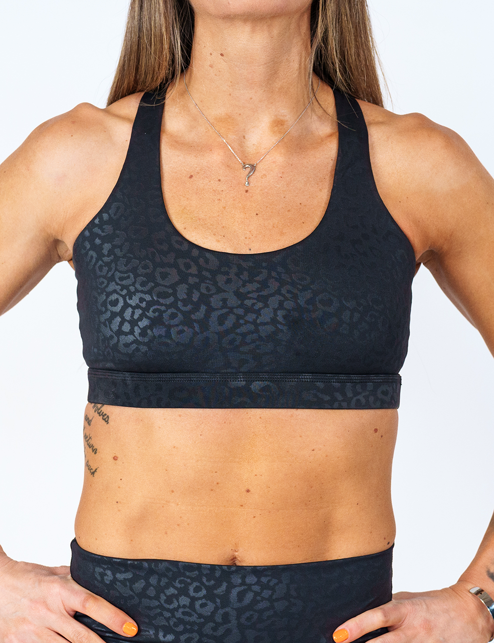 front view of black on black leopard print sports bra