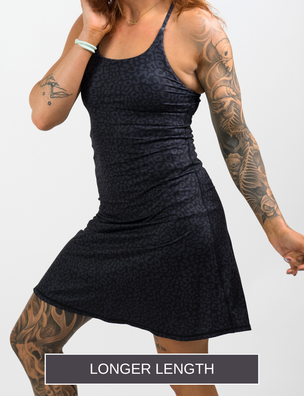 model wearing the longer length black leopard dress against a white background