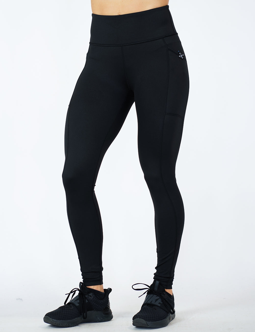 front of the solid black full length legging with a subtle CVG logo on the pocket against a white background