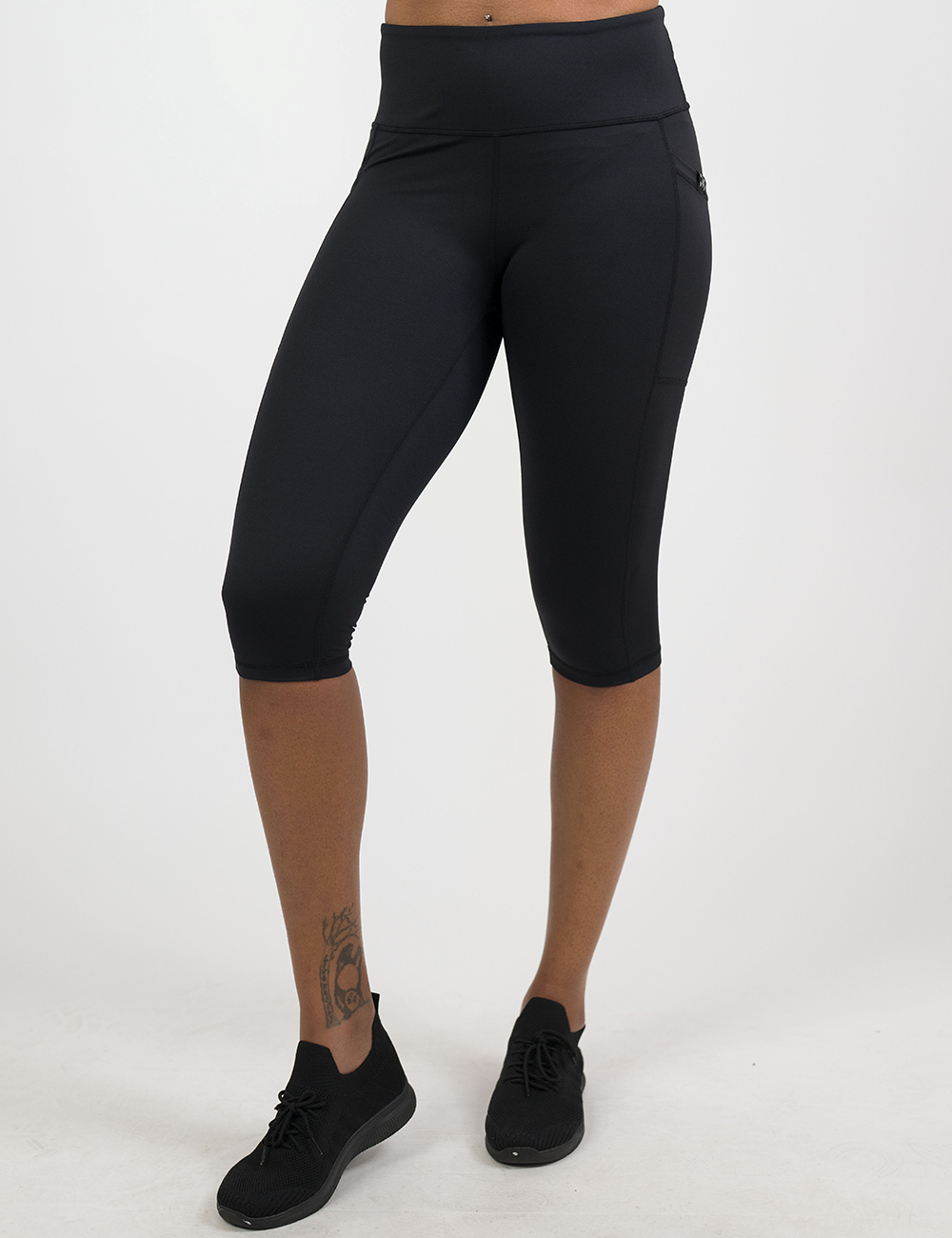 front of the cropped solid black leggings against a white background