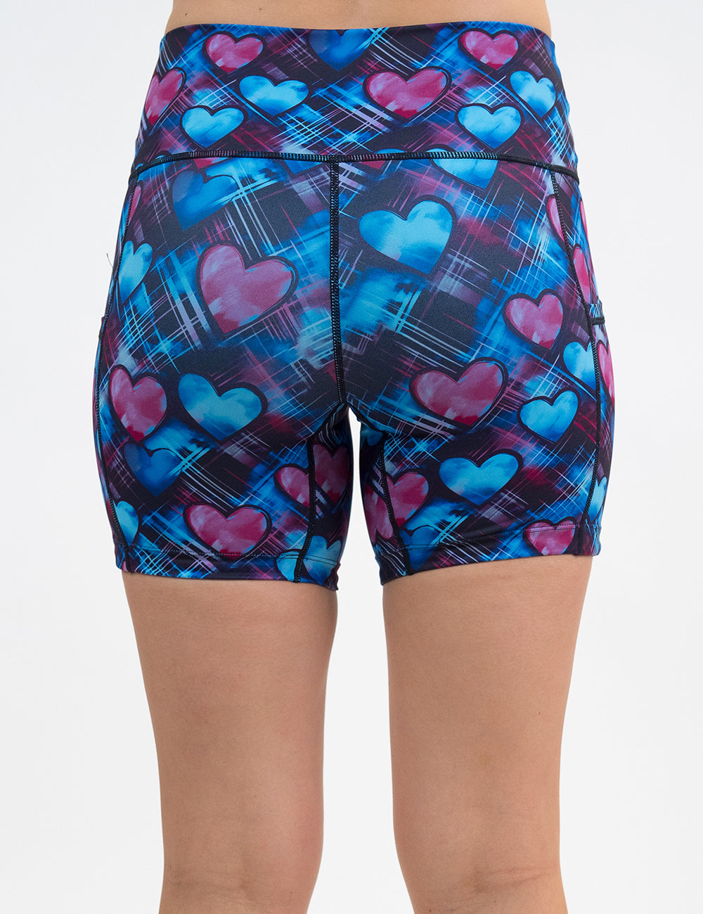 back of the 5 inch blue and pink hearts pattern against a dark stitched background shorts against a white background