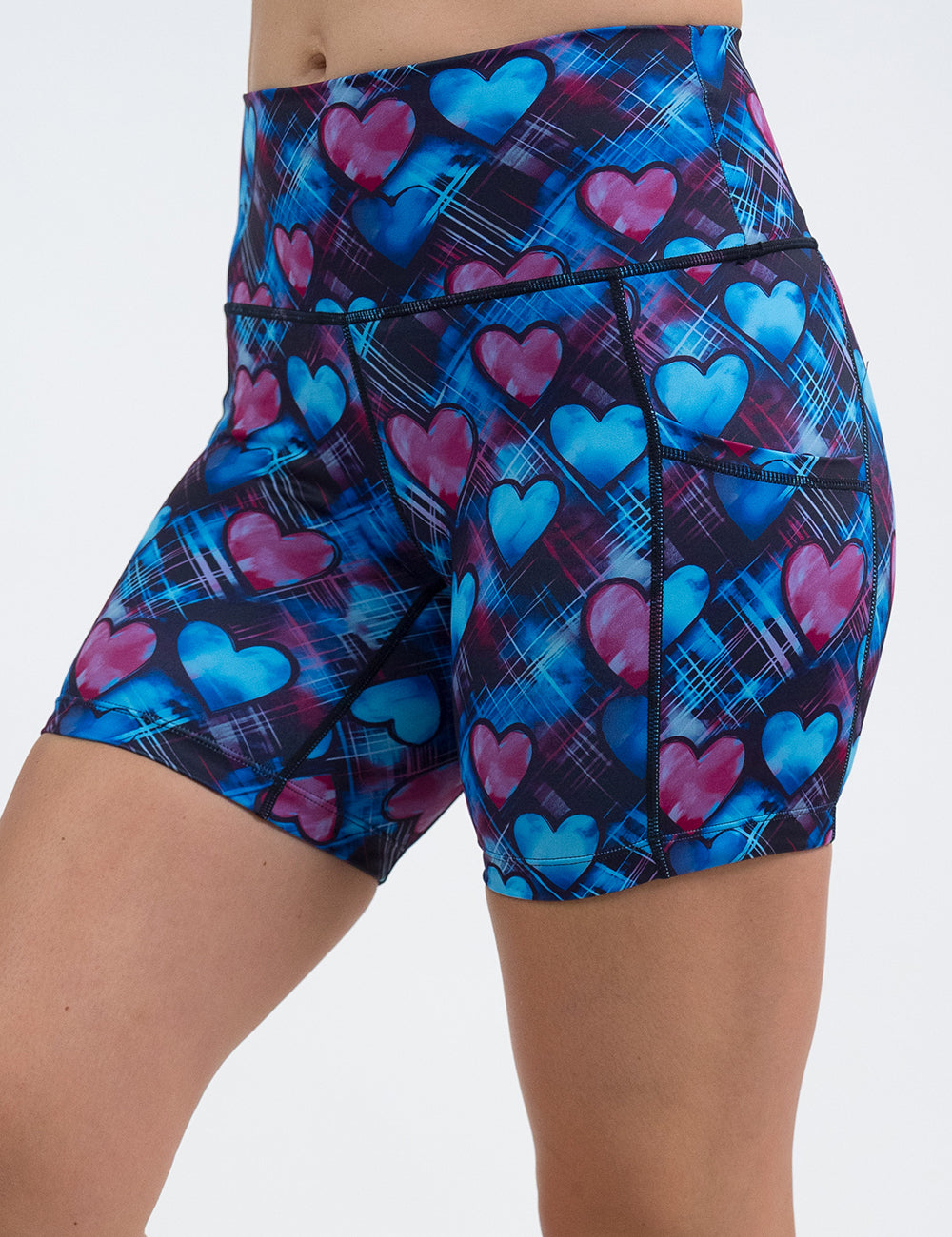 front of the 5 inch blue and pink hearts pattern against a dark stitched background shorts against a white background