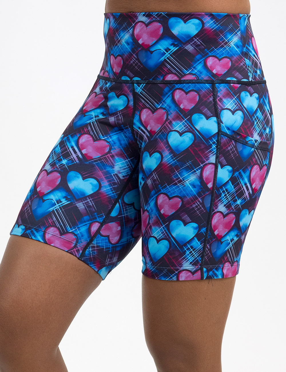 front of the 7 inch blue and pink hearts pattern against a dark stitched background shorts against a white background