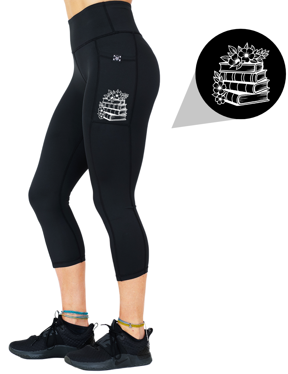 model wearing the books and flowers graphic capri solid black leggings against a white background