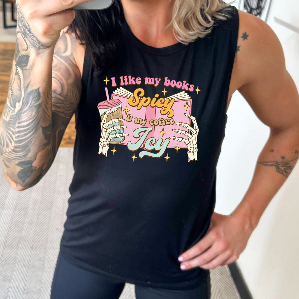 model wearing a black muscle tank top with the saying "I Like My Books Spicy And My Coffee Icy" on it