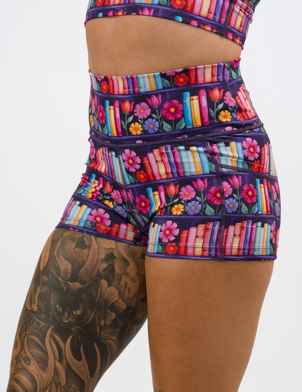 close up of the 2.5 inch brightly colored books and flower print shorts facing the front against a white background