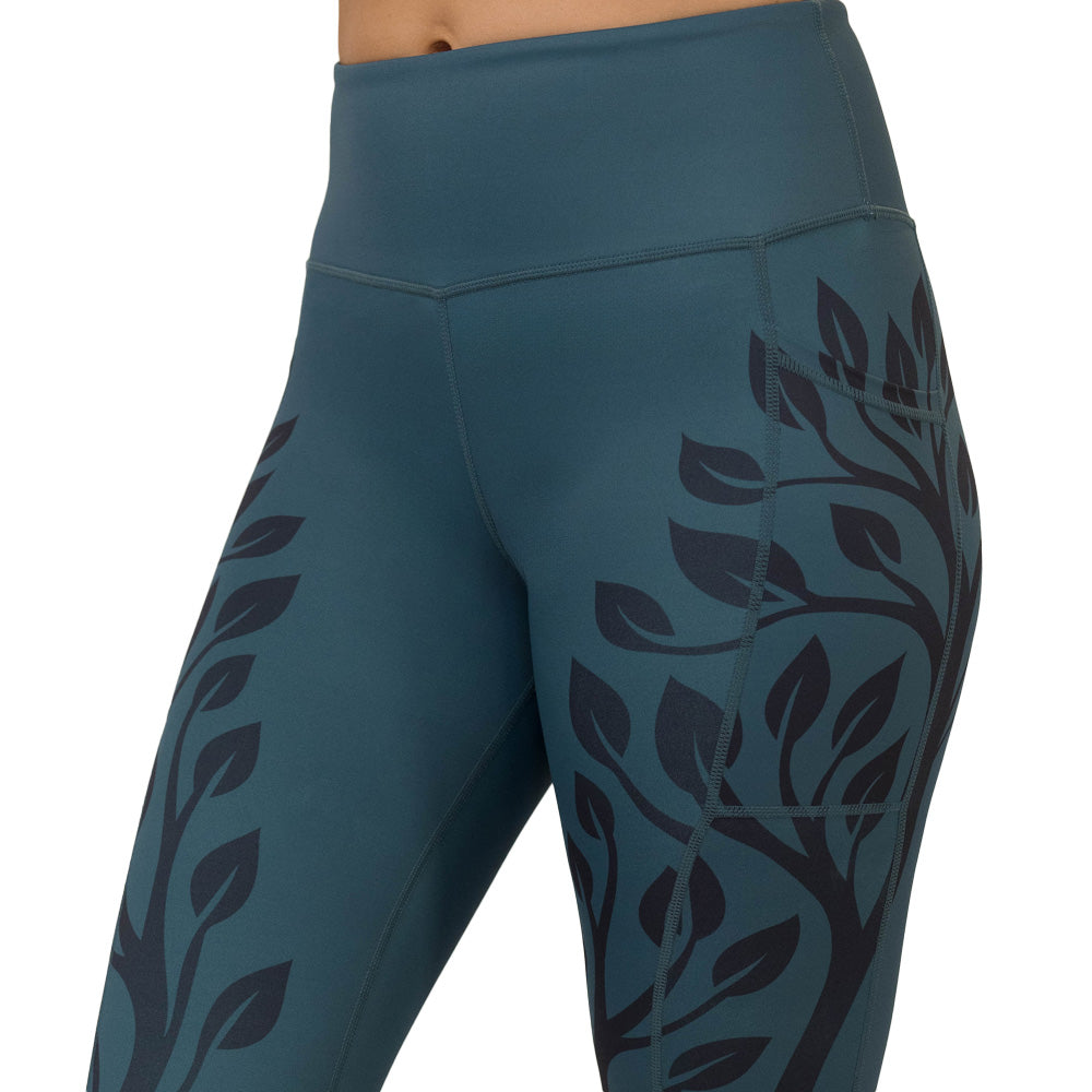 Teal leggings with black leaf pattern on a white background